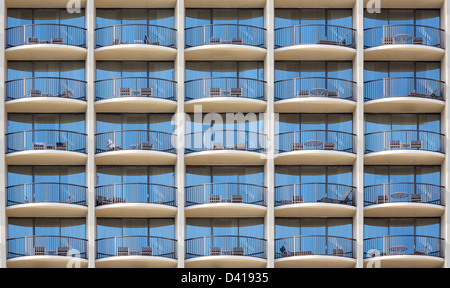 Pattern of hotel room balconies in modern building with all door closed and regular Stock Photo