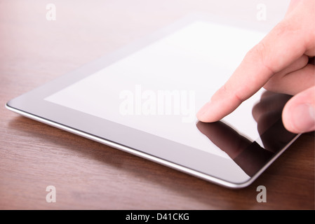 hand touching screen on modern digital tablet pc. Close up Stock Photo