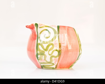 A pink ceramic milk cup from Lampang, Thailand isolated on white background Stock Photo
