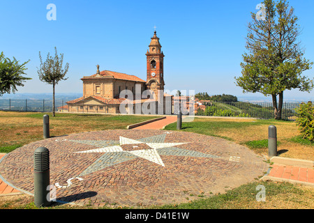 View on red brick church under blue sky from small park in town of Diano D'Alba in Piedmont, Northern Italy. Stock Photo