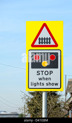 stop when lights show railway level crossing sign England UK Stock Photo
