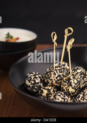 Spicy goat cheese balls rolled in sesame seeds. Stock Photo
