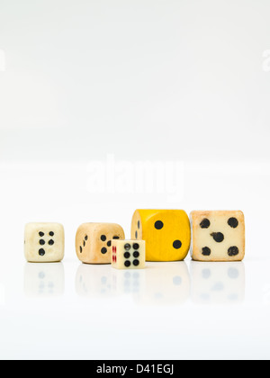 Used white and yellow dices isolated on white background Stock Photo