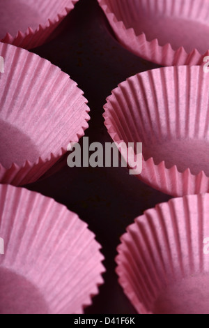 Bun cases ready to be filled with chocolate cupcake mixture Stock Photo