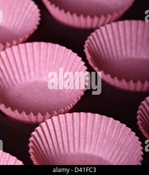 Bun cases ready to be  filled with chocolate cupcake mixture Stock Photo