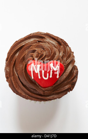 looking down on chocolate cupcake with the word mum iced on red heart for Mothering Sunday, Mothers Day isolated on white background - from above Stock Photo