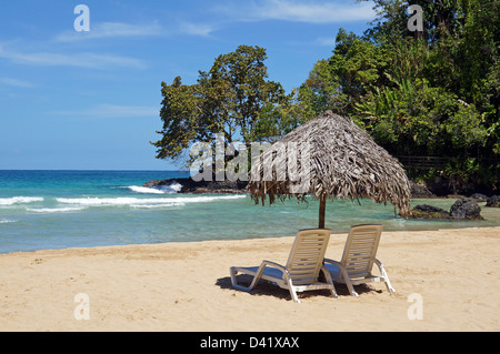 Two beach chairs with a thatched umbrella on pristine sandy beach, Central America, Panama Stock Photo