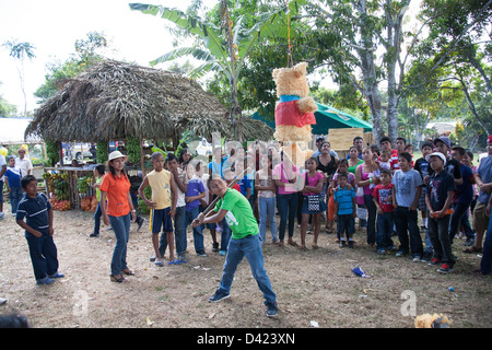 A Panamanian boy trying to break open a pinata at the Festival de la Naranja. Stock Photo