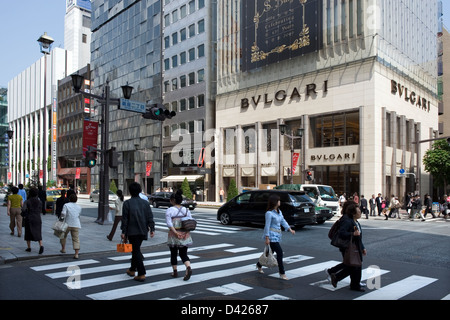 High fashion boutiques line both sides of Chuo-dori (Main Street) in the upscale Ginza shopping district in downtown Tokyo. Stock Photo