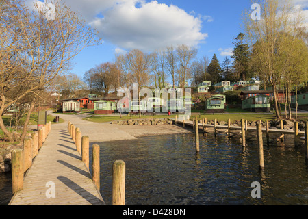 Wooden jetty and static caravans in lakeside Fallbarrow holiday park on Windermere in Lake District Bowness Cumbria England UK Stock Photo