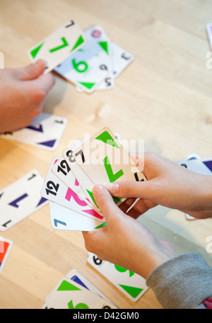 Germany, kids playing Uno Stock Photo