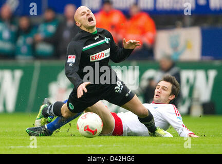 Fuerth's Jozsef Varga (F) and Hamburg's Milan Badelj vie for the ball during the match Hamburger SV - SpVgg Greuther Fuerth in the Imtech Arena in Hamburg, Germany, 02 March 2013. PHOTO: AXEL HEIMKEN   (ATTENTION: EMBARGO CONDITIONS! The DFL permits the further utilisation of up to 15 pictures only (no sequntial pictures or video-similar series of pictures allowed) via the internet and online media during the match (including halftime), taken from inside the stadium and/or prior to the start of the match. The DFL permits the unrestricted transmission of digitised recordings during the match ex Stock Photo