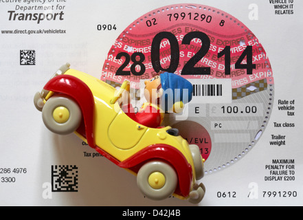 car tax disc and model toy noddy car Stock Photo