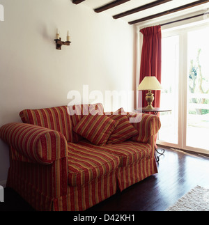 Red Pink Striped Loose Cover On Sofa In Simple White Living Room
