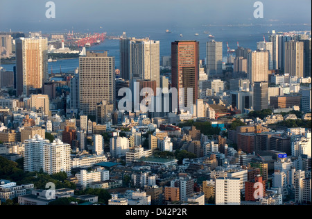 Daytime aerial view of metropolitan downtown Tokyo city skyline with high-rise buildings including Tokyo Bay Stock Photo