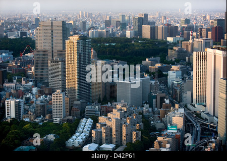 Daytime aerial view of metropolitan downtown Tokyo city skyline with high-rise buildings including Imperial Palace Stock Photo