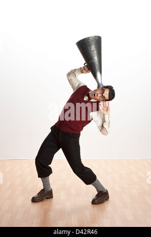 Freiburg, Germany, a man listens through a megaphone Stock Photo