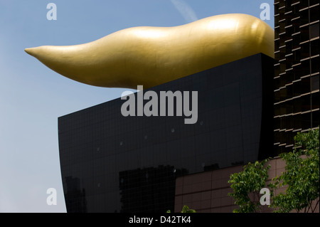 Unique gold flame sculpture, or Flamme d'Or, at Asahi Super Dry Beer Hall designed by French architect Philippe Starck. Stock Photo