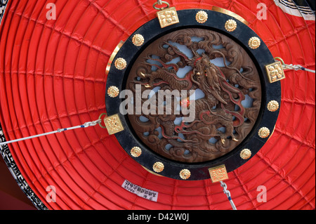 Detail of wood carved dragon motif on bottom of giant paper chochin lantern hanging inside gate at Sensoji Temple, Tokyo Stock Photo