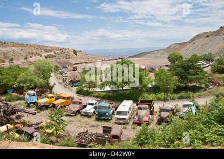 An old vehicle and automobile junk yard in the middle of a desert. Stock Photo