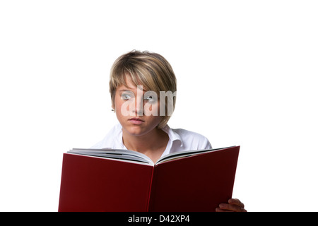 Freiburg, Germany, Portrait of a young student who is peering behind a book Stock Photo