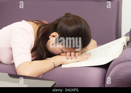 Asian woman lying sleeping on the book Stock Photo