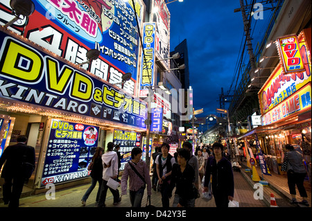 Neon signs from adult video and game shops light up the night in the entertainment district of Okachimachi, Tokyo. Stock Photo
