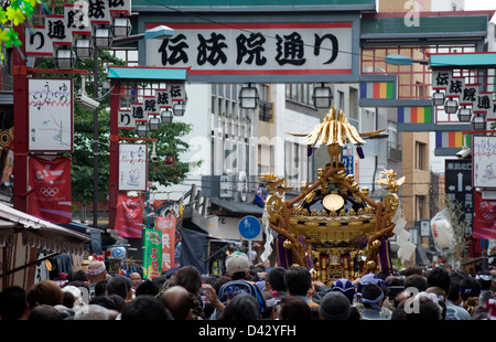 People carry a gold decorated sacred mikoshi portable shrine in the Sanja Matsuri Festival, one of Tokyo's big three events. Stock Photo