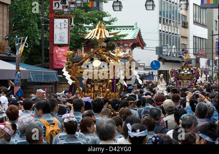 People carry a gold decorated sacred mikoshi portable shrine in the Sanja Matsuri Festival, one of Tokyo's big three events. Stock Photo