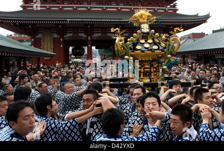 Gold decorated sacred mikoshi portable shrine carried around Sensoji Temple Hozomon Gate during Sanja Matsuri Festival. Stock Photo