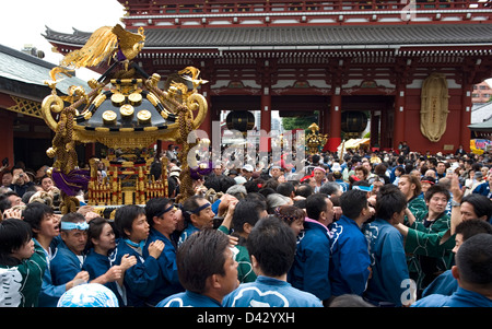 Gold decorated sacred mikoshi portable shrine carried around Sensoji Temple Hozomon Gate during Sanja Matsuri Festival. Stock Photo