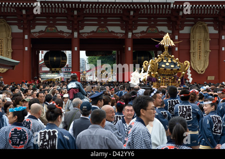 Gold decorated sacred mikoshi portable shrine carried around Sensoji Temple Hozomon Gate during Sanja Matsuri Festival. Stock Photo