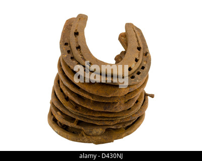 stack of old retro horseshoes horse shoes isolated on white background Stock Photo