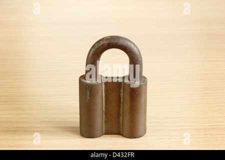 rusty old metal padlock on wooden background Stock Photo