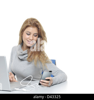 Woman with the laptop and mobile phones sand message Stock Photo