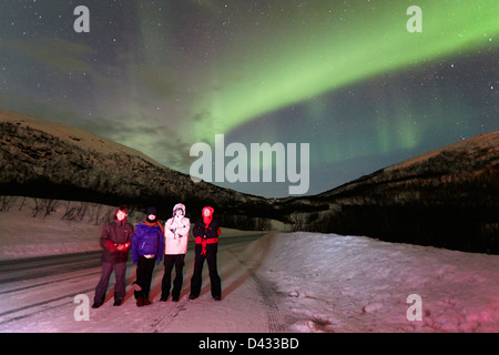 tourists watching northern lights aurora borealis near tromso in northern norway europe Stock Photo