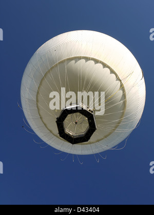 White hot air balloon rising up in the air Stock Photo