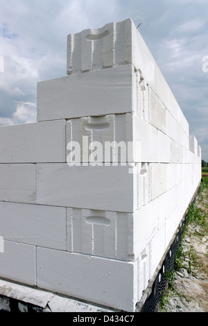 Unfinished house wall made from white aerated autoclaved concrete blocks Stock Photo