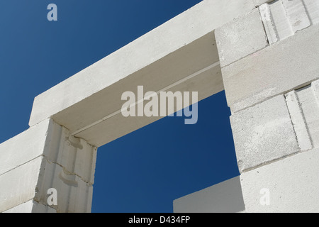 Prefabricated aerated autoclaved concrete lintel placed on house wall blocks shot over blue sky Stock Photo