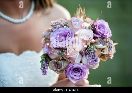 Close up of bridal bouquet  held out in front of bride Stock Photo