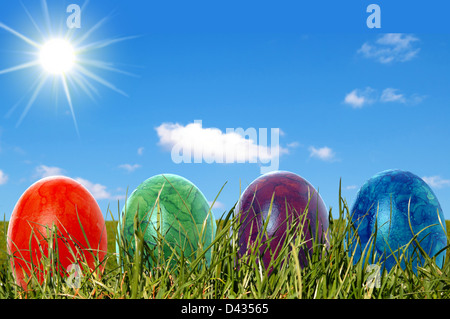 Easter eggs in a meadow with sun Stock Photo