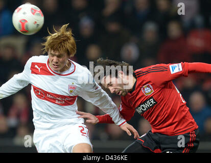 Leverkusen's Gonzalo Castro (R) vies for the ball with Stuttgart's Gotoku Sakai during the Bundesliga soccer match between Bayer 04 Leverkusen and VfB Stuttgart at BayArena in Leverkusen, Germany, 02 March 2013. PHOTO: Federico Gambarini