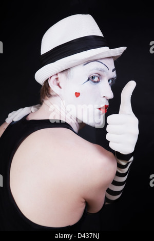 Theater actor with mime makeup on a black background Stock Photo