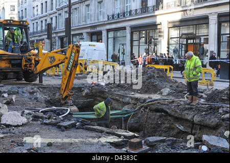 Regent Street, London, UK. 3rd March 2013. Workmen and machinery at the site of the burst water main on Regent Street. The burst water main on Regent Street at the junction with Vigo Street is being repaired, Regent Street is still closed to traffic from Conduit Street to Piccadilly Circus. Credit: Matthew Chattle/Alamy Live News Stock Photo