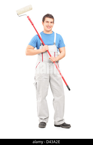 Full length portrait of a confident painter in a uniform with a brush isolated against white background Stock Photo