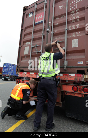 At a CBP port of entry inspection station, officers conduct thorough ...