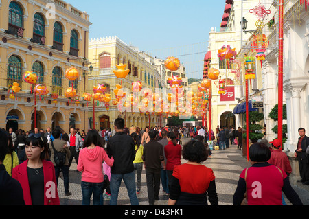 Crowds of people in Macau Senate Square with Chinese New Years Decorations Stock Photo