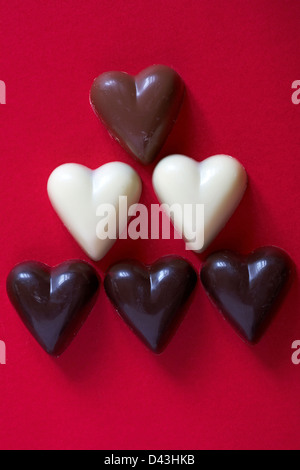 chocolate hearts set on red background  - ideal for Valentine day, Valentines day Stock Photo