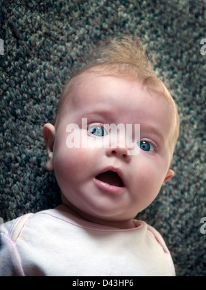 newborn infant baby looking at camera Stock Photo