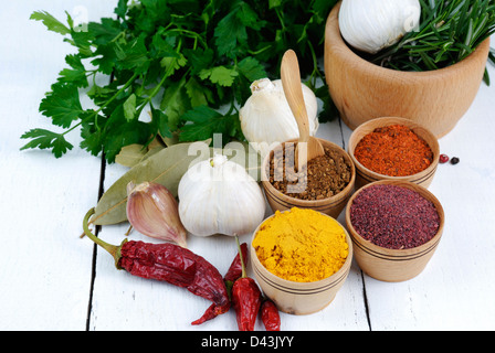 Different kinds of seasonings and herbs on the white oak table Stock Photo